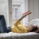 student on bed reading book